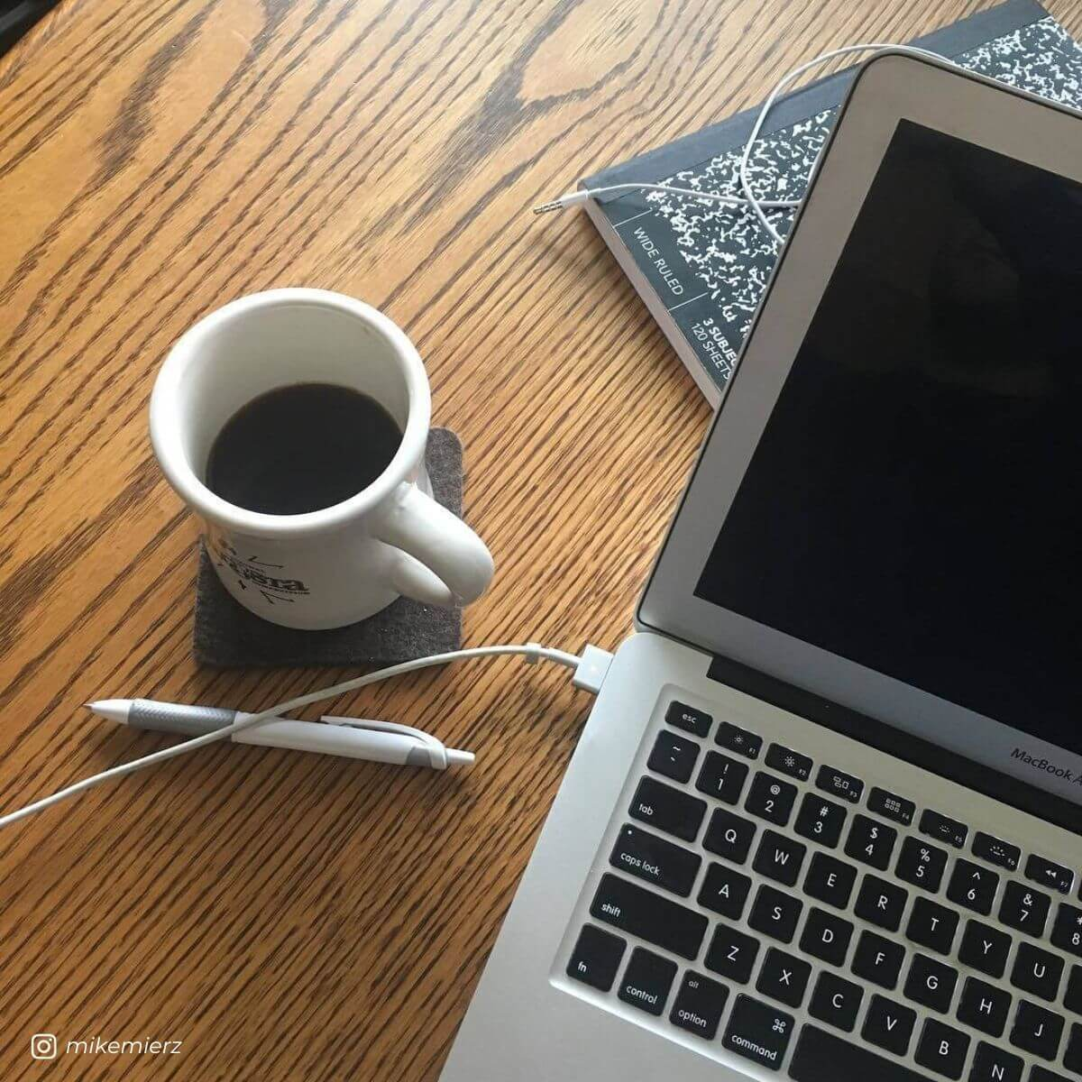 Instagram Content Plan and Strategy session: Coffee, pen & paper, and laptop computer on a desk.